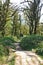 Photo of a girl walking along the trail path through boxwood forest