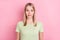 Photo of girlish nervous stupid blonde lady bite lip make mistake wear green t-shirt isolated on pink background