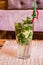 Photo of glass of drink non-alcoholic mojito with a straw on fabric napkin