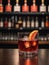 Photo Of Glass Of Negroni Vermouth Campari Drink On Bar And Bar View. Generative AI