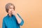 Photo of gloomy woman with bob hairstyle dressed stylish shirt looking at empty space close nose isolated on beige color