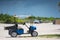 Photo of a golf cart on the beach shot with telephoto lens