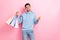 Photo of good mood positive guy dressed blue sweatshirt buying bargains instagram facebook shop isolated pink color