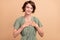 Photo of grateful sincere lady hands chest close eyes enjoy harmony wear green dress isolated beige color background