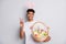 Photo of guy hold easter basket show v-sign wear bunny ears headband white t-shirt  grey background
