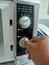 Photo of hand adjusting microwave oven timer button.