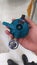 photo of hand holding regulator for gas cylinder