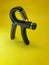 Photo of a handgrip sports equipment with a yellow background