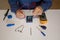 Photo of the hands of a man using a tester to repair an electrical board of a battery pack. Homemade repair work