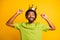 Photo of handsome afro man happy smile excited show point index fingers crown wear green t-shirt isolated over yellow