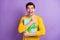 Photo of handsome astonished man arms hold hug giftbox open mouth isolated on violet color background