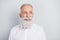 Photo of handsome cheerful grey hair old man look empty space wear white shirt isolated on grey color background