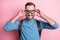 Photo of handsome cute young guy wear blue pullover arms glasses backpack ready to skydive isolated pink color