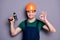 Photo of handsome masculine worker guy skilled engineer hold electric drill showing okey symbol wear t-shirt safety