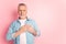 Photo of handsome retired man arms on heart promise honest grateful isolated over pink color background