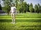 Photo of a handsome young man standing on a lush green field