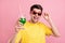 Photo of happy charming cheerful man hold cocktail cheers wear sunglass isolated on pink color background