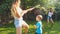 Photo of happy children having water gun fight at house backyard garden. Family playing and having fun outdoors at