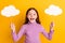 Photo of happy excited crazy amazed surprised little girl hold two paper clouds  on yellow color background