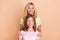 Photo of happy family mom and daughter smile care harmony isolated on pastel beige color background