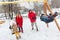 Photo of happy girl and boy swinging in winter in park with parents