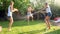 Photo of happy laughing family splashing water with water guns and garden hose at backyard. People playing and having