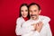 Photo of happy man and woman husband wife joyful couple hug harmony good mood isolated on red color background