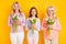 Photo of happy nice three women generation hold tulip flowers spring holiday celebrate isolated on yellow color