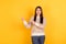 Photo of happy nice young lady point look fingers empty space promo advert isolated on yellow color background