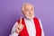 Photo of happy old man hold finger attention caution warning wear red vest isolated on purple color background