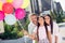 Photo of happy smiling positive family outside outdoors mom dad celebrate daughter birthday girl hold balloons