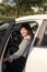 Photo of happy young mixed race woman sitting inside her new car. Concept for car rental