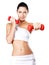 Photo of a healthy training young woman with dumbbells