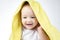 Photo of hidden eleven-month-old baby under yellow towel