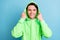 Photo of hipster funny guy hands hold hood white smile wear green sweatshirt isolated blue color background
