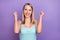 Photo of hooray blond millennial lady hands fists wear blue top isolated on violet color background