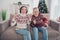 Photo of hooray couple aged lady man sit watch tv wear sweater jeans at home