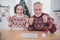 Photo of hooray couple elder lady man sit talk online wear sweater at home