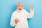 Photo of hooray elder grey hairdo man yell wear white pullover isolated on blue color background
