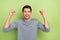 Photo of hooray millennial brunet guy yell wear grey pullover isolated on green color background