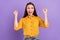 Photo of hooray young lady hands fists yell wear yellow shirt isolated on vivid violet color background