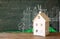 Photo of house and background of blackboard and city drawings. real estate and family house concept