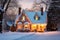 Photo of house decorated for Christmas under the snow. Generative AI