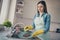 Photo of house wife clean dirty plates after party weekend activity wear dotted apron bright kitchen