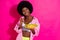 Photo of hungry sweet dark skin lady wear casual shirt eating cereals looking empty space isolated pink color background