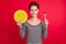 Photo of hungry sweet young lady wear striped clothes holding plate fork smiling isolated red color background