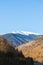 Photo of the Iezer-Papusa mountains with their snowy peaks and the orange nature took at Rausor Lake and Dam, Arges, Romania