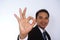 Photo image of a handsome attractive young Asian businessman with Ok sign hand