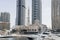 Photo of the imposing large Mohammed Bin Ahmed Al Mulla Mosque between the high rise buildings of the Dubai Marina on