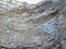 Photo of an imposing rock wall taken from the chasm of Fontaine de Vaucluse in Provence